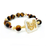 ‏GOLD PLATED BRACELET IN THE NAME OF AL-JALALAH ( AL-WAHHAB ) WITH TIGER-EYES , SEASHELL , BROWN Agate  .