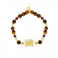 A bracelet in the name of Al-Jalalah Al-Noor, crafted on white seashells, with tiger eyes, brown quartz and seashells A bracelet in the name of Al-Jalalah Al-Noor, crafted on white seashells, with tiger eyes, brown quartz and seashells