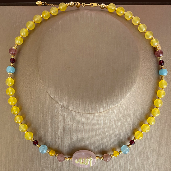 A pink quartz stone necklace crafted with the name of His Majesty (Allah) on it, with aquamarine , cherry quartz, pink quartz ، garnit ,yellow agate A pink quartz stone necklace crafted with the name of His Majesty (Allah) on it, with aquamarine , cherry quartz, pink quartz ، garnit ,yellow agate