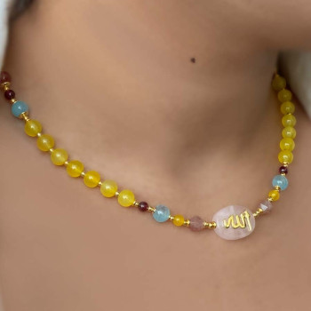 A pink quartz stone necklace crafted with the name of His Majesty (Allah) on it, with aquamarine , cherry quartz, pink quartz ، garnit ,yellow agate 