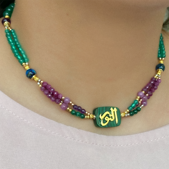 A MALACHITE STONE NECKLACE, HANDCRAFTED WITH THE NAME OF HIS MAJESTY (AL-NOOR), WITH RUBI , AZURITE , AMETHYST AND GREEN AGATE 18K GOLD PLATED. A MALACHITE STONE NECKLACE, HANDCRAFTED WITH THE NAME OF HIS MAJESTY (AL-NOOR), WITH RUBI , AZURITE , AMETHYST AND GREEN AGATE 18K GOLD PLATED.