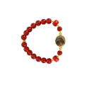 A horse seashell with a red coral stone, and a red agate stone