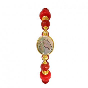 A horse seashell with a red coral stone, and a red agate stone