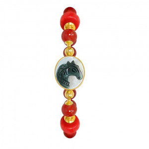 A horse seashell with a red coral stone, and a red agate stone