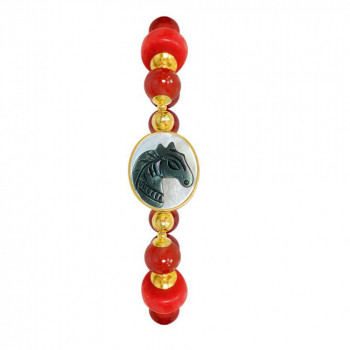 A horse seashell with a red coral stone, and a red agate stone