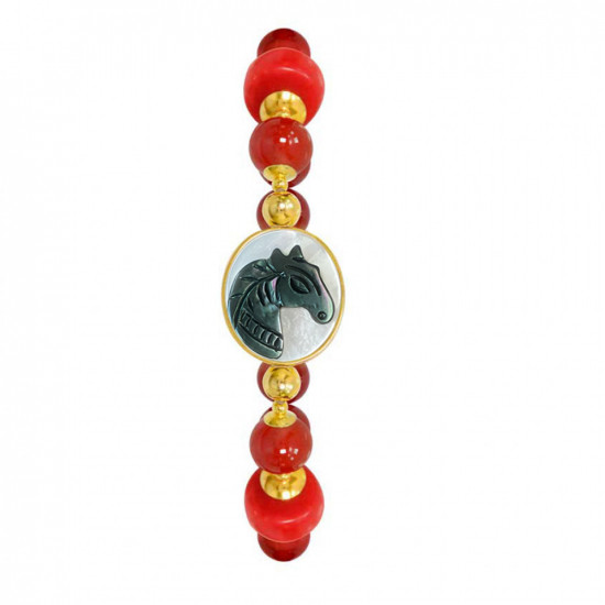 A horse seashell with a red coral stone, and a red agate stone