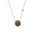 Gold-plated Silver chain of prominent white and black horse seashell with a red coral stone Gold-plated Silver chain of prominent white and black horse seashell with a red coral stone