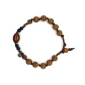 STRING BRACELET WITH GOLDEN CORAL, COCONUT WOOD, AND AGARWOOD