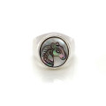 A wide silver ring with a small two-tone horse seashell