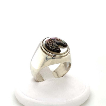 A wide silver ring with a small two-tone horse seashell