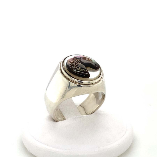 A wide silver ring with a small two-tone horse seashell