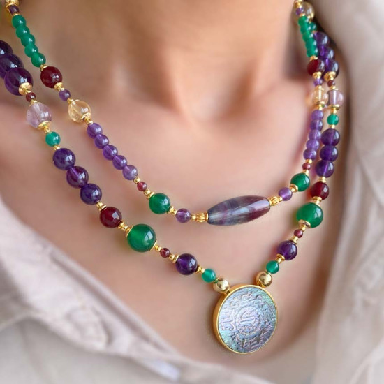 A NECKLACE MADE OF SAUDI POUND SHELL WITH TOURMALLINE , AMETHYST, GREEN AGATE AND AMACITRINE 