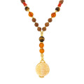 A NECKLACE MADE OF SAUDI GOLD POUND SHELL WITH TIGER-EYE , JASPER , AMBER , CORAL AND COKE WOOD A NECKLACE MADE OF SAUDI GOLD POUND SHELL WITH TIGER-EYE , JASPER , AMBER , CORAL AND COKE WOOD