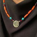 A NECKLACE MADE OF SAUDI POUND SHELL WITH CORAL, RUBY AND TURQUOISE