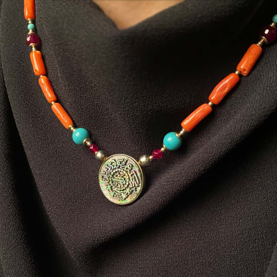 A NECKLACE MADE OF SAUDI POUND SHELL WITH CORAL, RUBY AND TURQUOISE