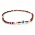 Wood anklet with eye, pearls and garnet 
